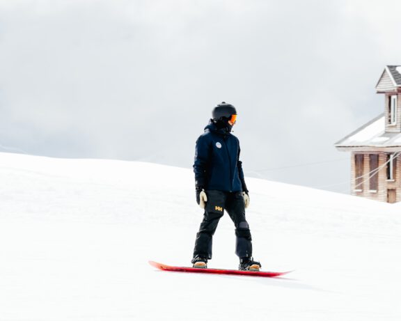 Snowboard instructor riding the slope.