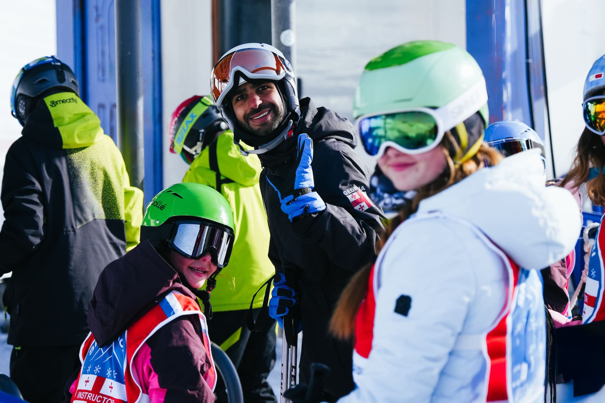 Ski instructor with his group at the ski lift.