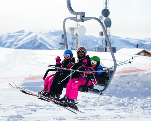 Kids with their ski instructor on the ski lift.