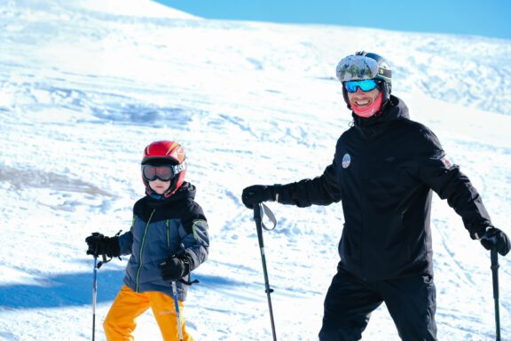 ski instructor with his student on the slopes of Gudauri.