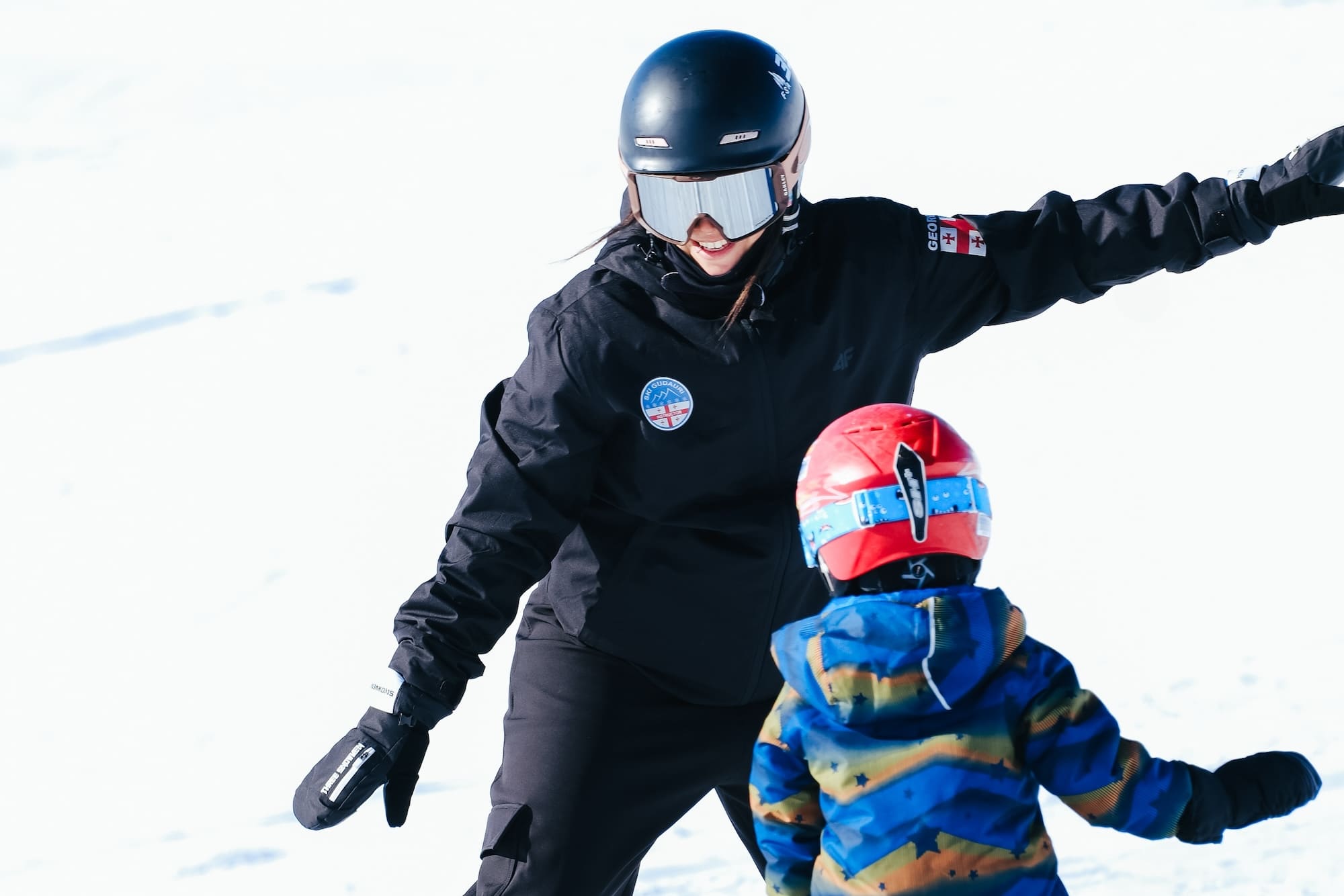 Female Ski Instructor teaching kids, Gudauri Ski Resort.